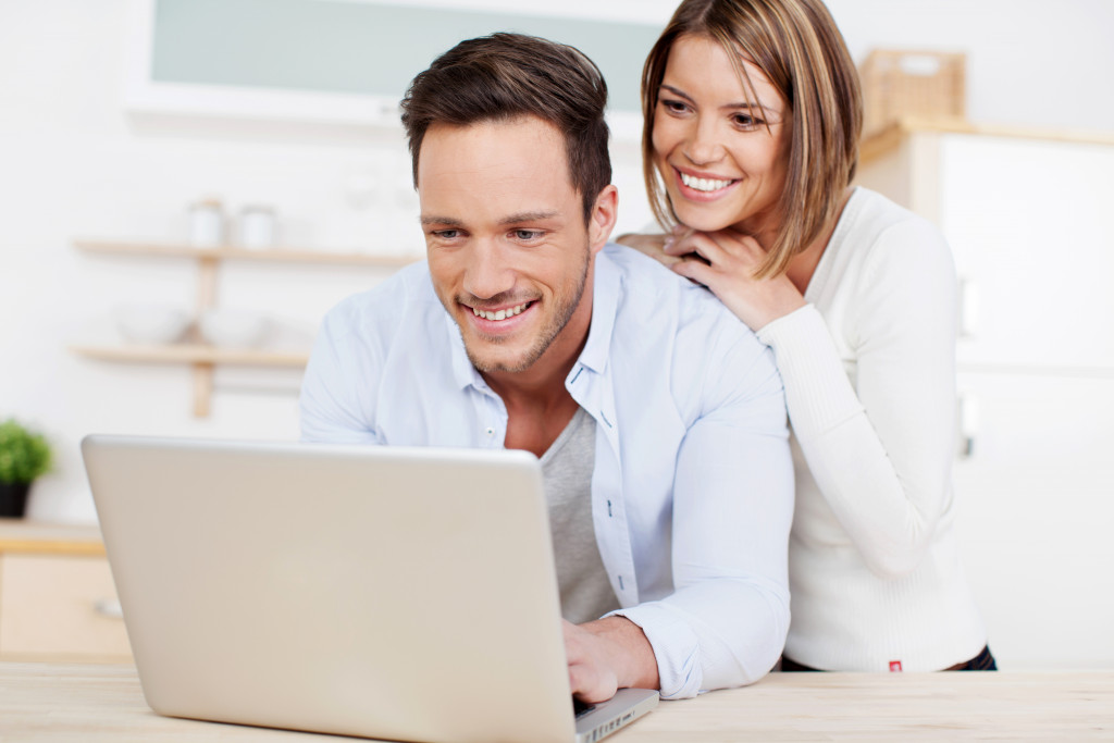 man and woman looking at the laptop