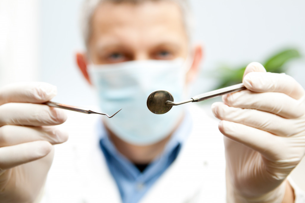 dentist holding medical tools