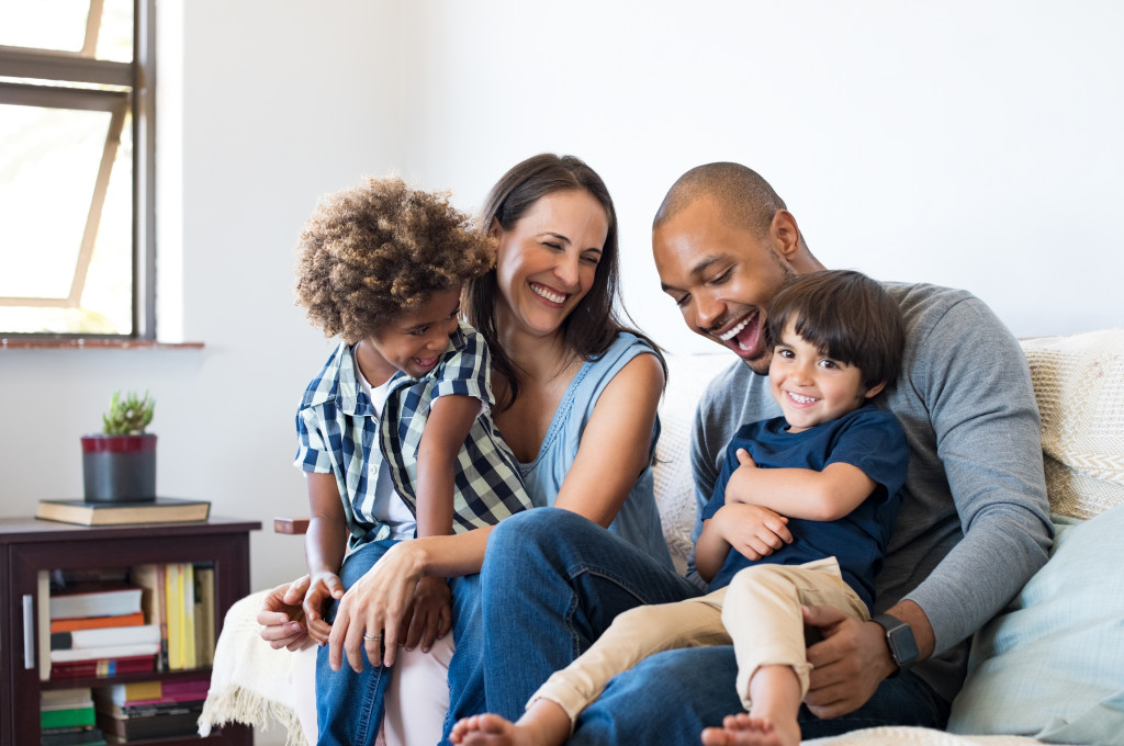 happy multiethnic family in sofa