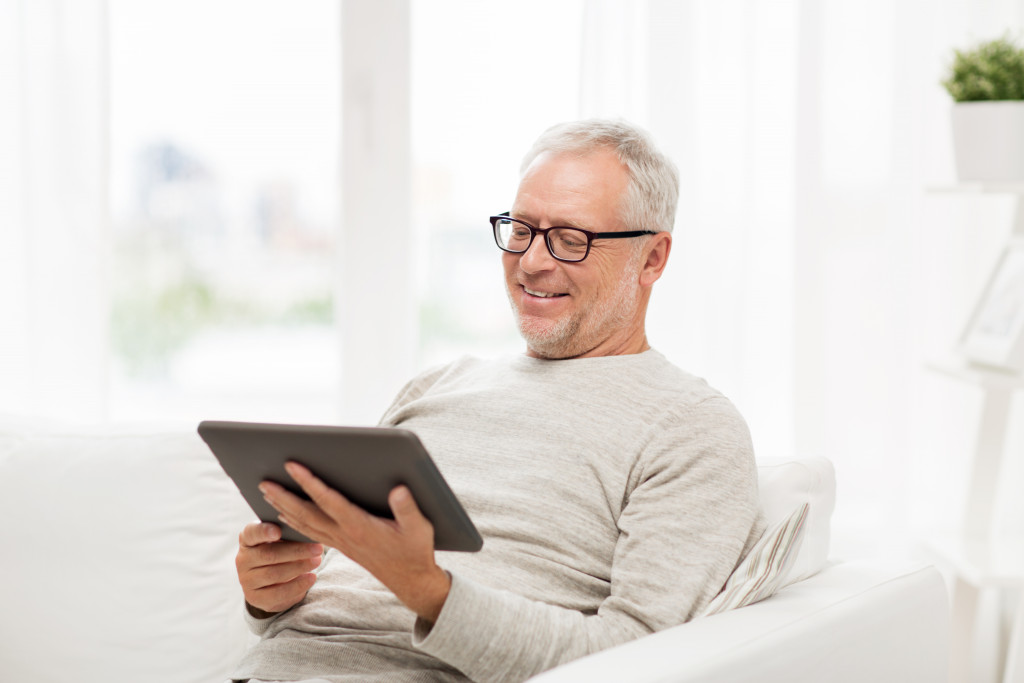 Retiree talking to loved ones through technology