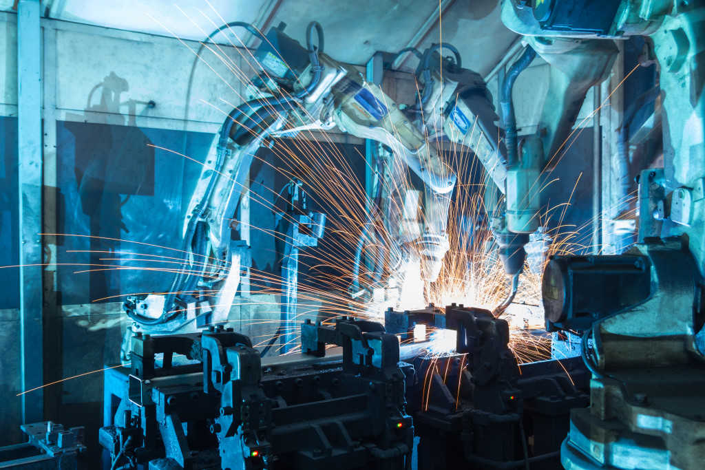 robots welding and controlling steel in factory