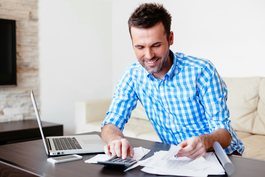 man in checkered and paying online