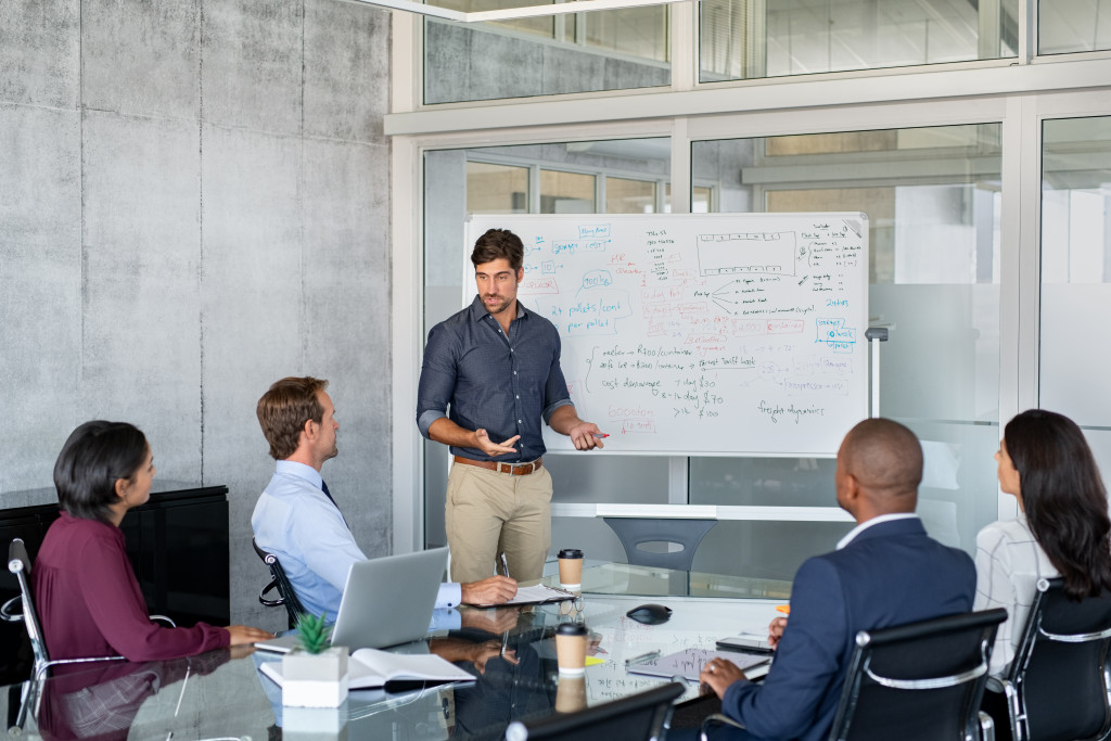 Successful business man giving reports to his colleagues.